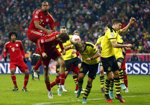 Boateng and Mueller of Bayern Munich attempt to score during their German first division Bundesliga soccer match against Borussia Dortmund in Munich